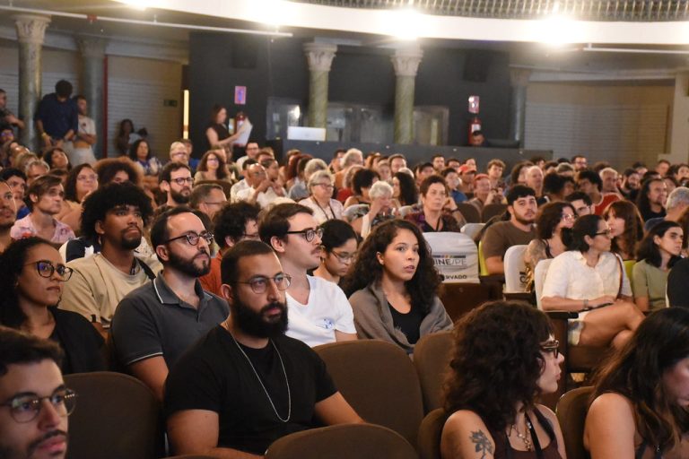 Foto de um várias pessoas sentadas em poltronas.